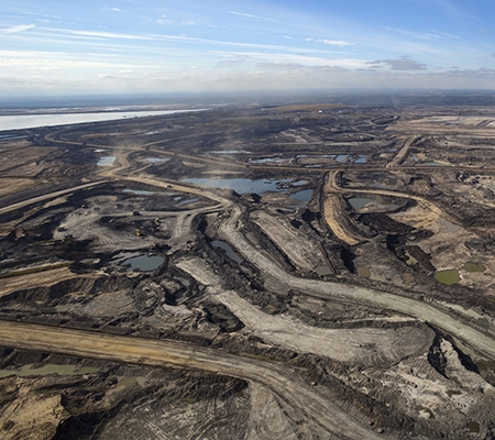 Expansive aerial view of a pit mining project in Alberta's oil sands near Fort McMurray.